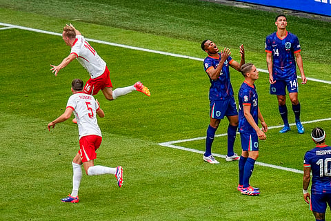 Adam Buksa celebrates Poland's opening goal 